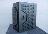 Front and angled side view of ROAMBUILT Universal Aluminum Storage Box showing MOLLE panels on the front and side, with visible black compression latch.
