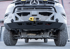 Close-up of the lower section of a Mercedes-Benz Sprinter's ROAMBUILT LoPro Front Bumper, highlighting the integrated steel 2-inch receiver hitch and 1-inch thick shackle mounts, all encased within a lightweight 5052 aluminum outer shell.