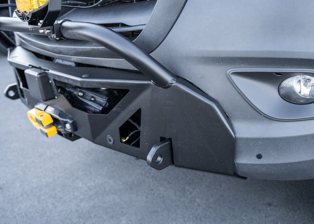 Close-up of the driver-side profile of a Mercedes-Benz Sprinter van showcasing the ROAMBUILT LoPro Front Bumper, featuring a lightweight aluminum shell, integrated bull bar, and a seamless design that adds only 3 inches of bulk while aligning precisely with the van’s body lines.