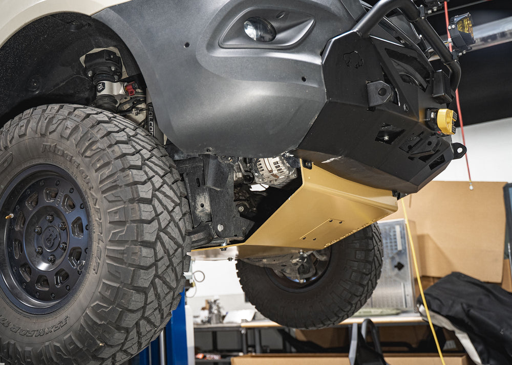 Underside view of the Mercedes Sprinter skid plate showing the full underbody coverage and the removable oil change access panel.