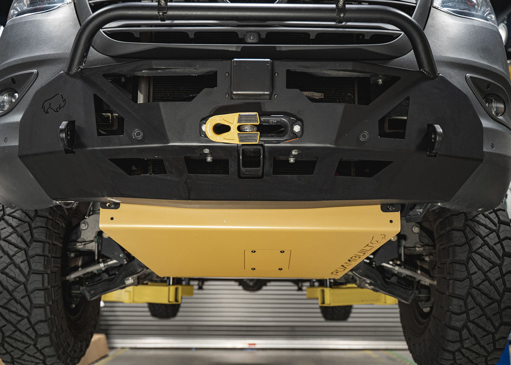 Eye-level view of the Mercedes Sprinter front featuring the Roambuilt skid plate with removable oil change access panel and LoPro front bumper, highlighting rugged protection and easy maintenance.