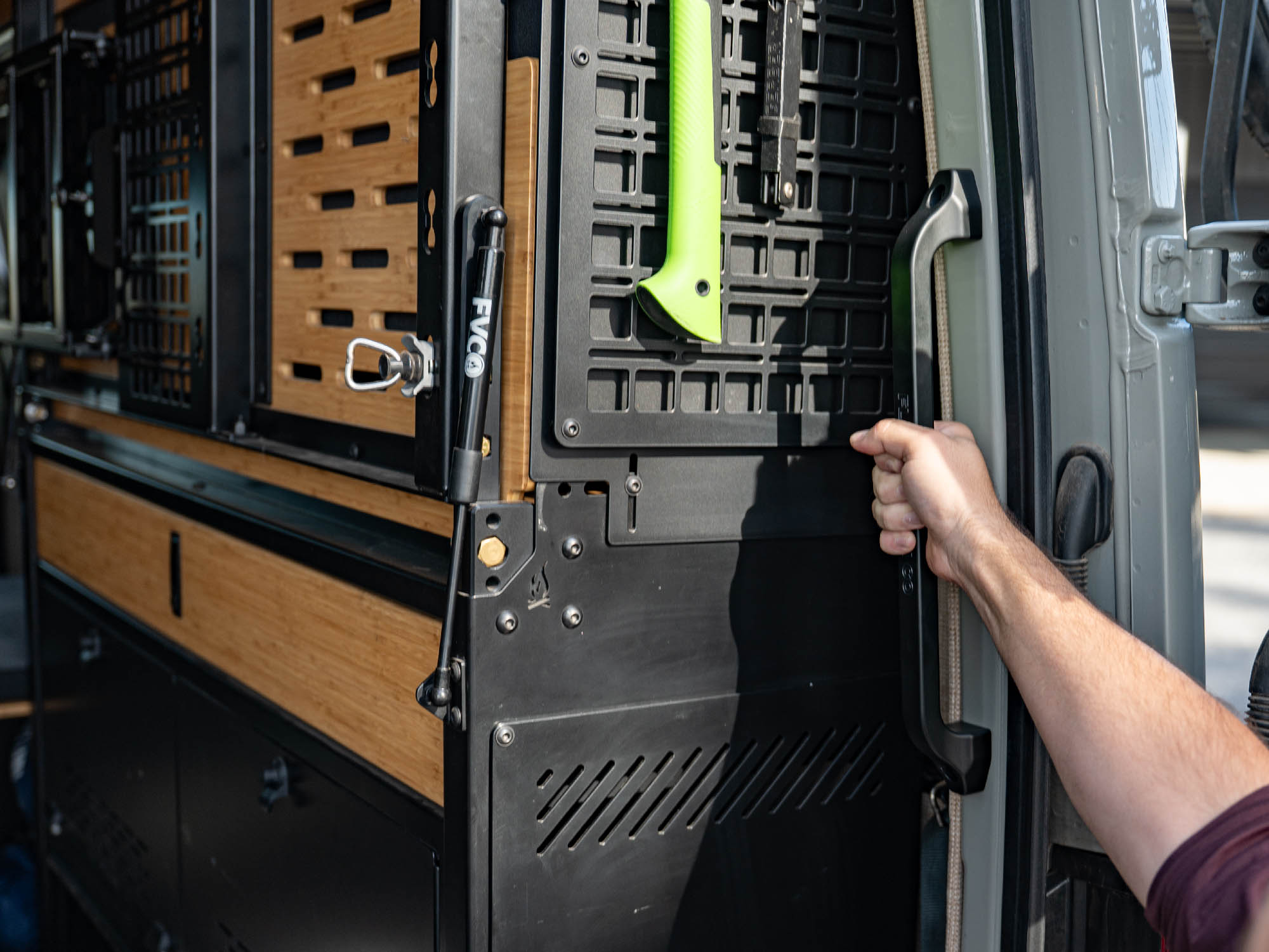 Person using Sprinter Van Rear Door Grab Handle to step into the rear doors