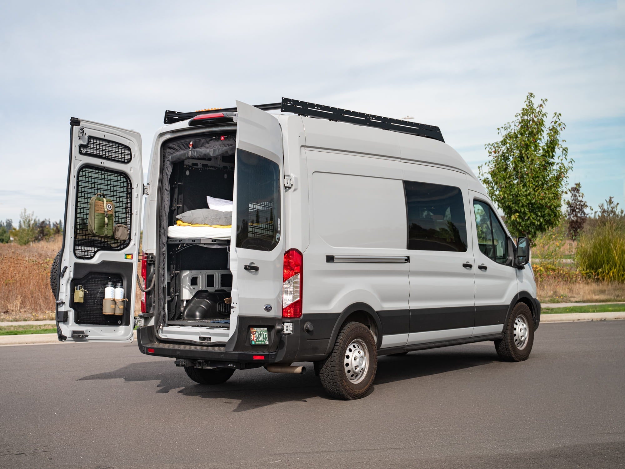 Ford Transit 48" high roof van with FVC Transit Rear Door Molle Panels and FVC Low Pro Roof Rack installed