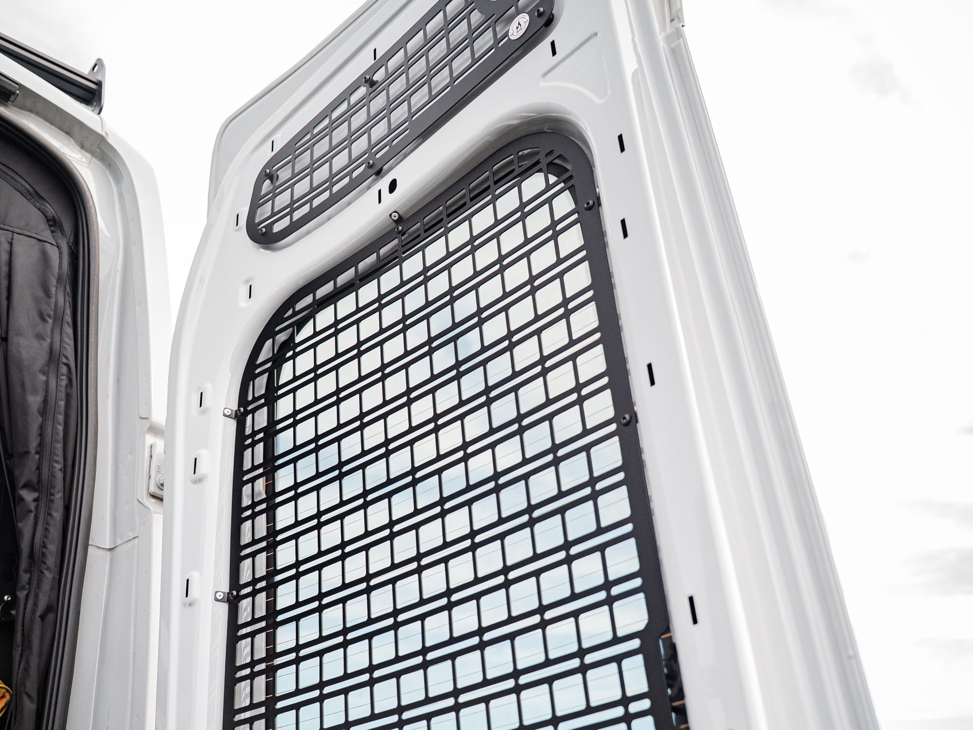 Upper and Rear Door Window panels of the Transit Rear Door Molle Panel installed in camper van