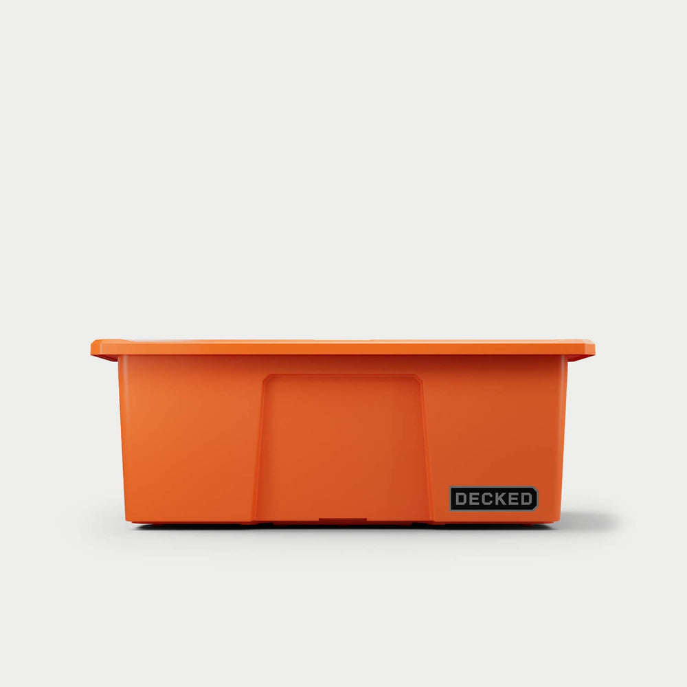 [A0041-DBIN-ORG] The front of one blaze orange Payloader bin, closed on a white background with a DECKED logo in the bottom right hand corner of the bin.